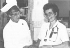 Historical photo of nurses standing outside the hospital.